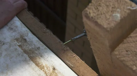 A man tightening the bolt with a drill Stock Footage 64776253