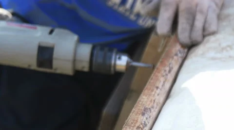 A man tightening the bolt with a drill Stock Footage 64776308