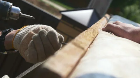 A man tightening the bolt with a drill Stock Footage 64776398