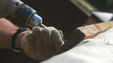 A man tightening the bolt with a drill Stock Footage 64776401