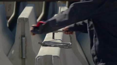 A man tightens a bolt into Stock Footage 263966878