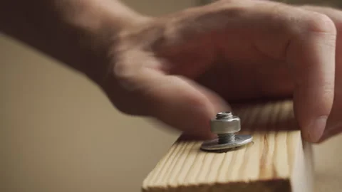 A man tightens a nut with a wrench while assembling furniture Stock Footage 282201423