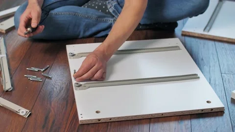 Man tightens the screws with a screwdriver Видео 146397116