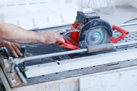 Man tiler construction worker electric porcelain cuts tiles Tile. Working w.. Fotos Stock