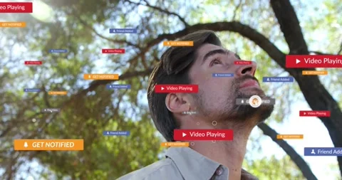 Man tilting head up under tree, starting tech UI badges around face, notifying Stock Footage 331287057