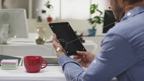 Man tilting tablet, activating expanding HUD nodes and visualizing technology Stock Footage 333019688