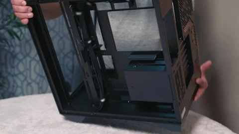 Man tilts and rotates computer case to inspect bottom and side sections Stock Footage 324592186