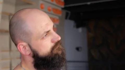 Man tilts head to side stretching neck. Young bearded man doing workout. 1080p Stock Footage 77801681