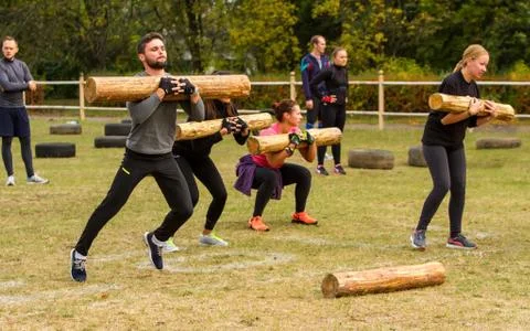 The man at the time of the jump with a  log. Stock Photos
