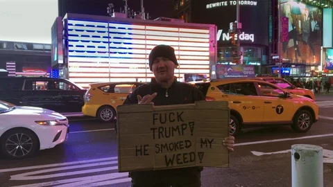 Man in Times Square Expresses His Poltical Views While Holding Anti-Trump Sign  Stock Footage 101308596