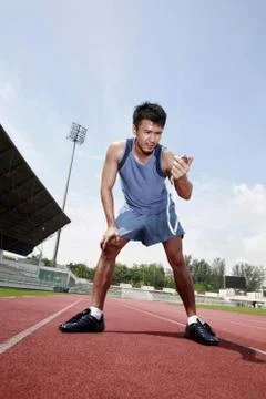 Man timing himself with stopwatch Stock Photos