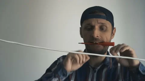 A man tinkering with an electric wire 스톡 동영상 155359284