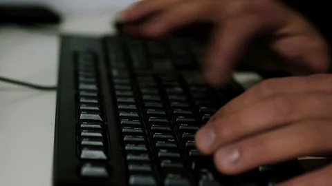 Man Tiping On A Mechanical Black pc Keyboard while working on web business Stock Footage 126789706