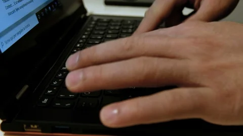 Man Tiping On A Mechanical Black pc Keyboard while working on web business Stock Footage 128001502