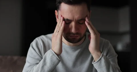 Man tired with hands on face physical and emotional discomfort Stock Footage 302262476