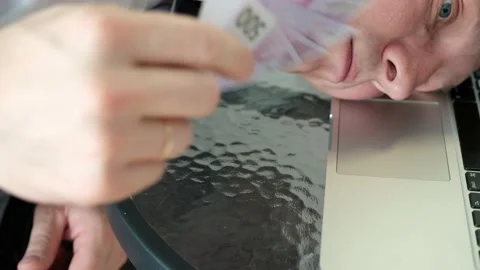 The man is tired at work and is cooling off with banknotes. 스톡 동영상 141671975