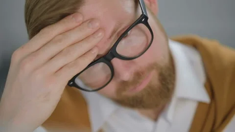 Man tired at work, looking stressed Stock Footage 123564161