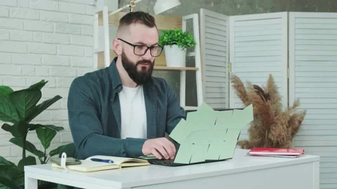 Man is tired from working on the computer, takes off glasses to rest his eyes. Stock Footage 156329725