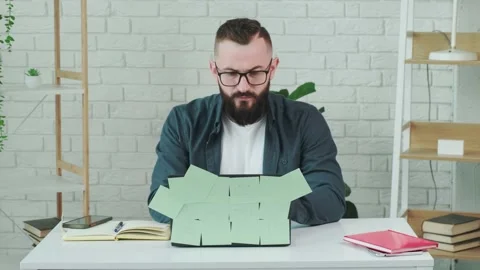Man is tired from working on the computer, takes off glasses to rest his eyes. Stock Footage 158450915