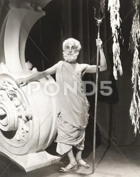 Man in toga holding trident Stock Photos