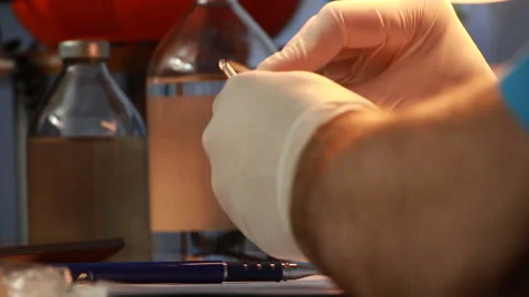 The man took a bottle of solution and typed it into the syringe Stock Footage 86880258