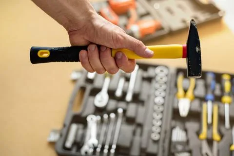 A man took a hammer from a case with tools for work. Close up Stock Photos