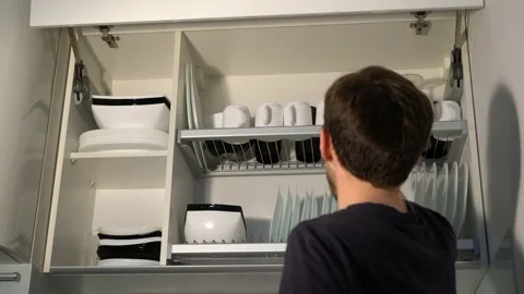 Man took a mug from the cupboard 库存影片 144376536