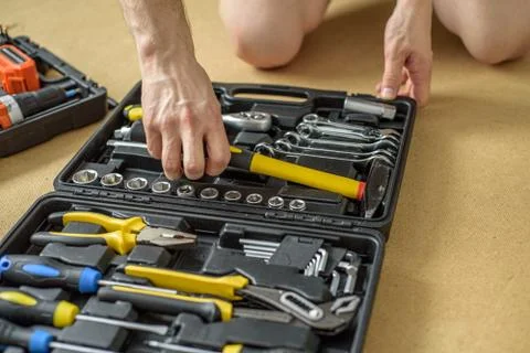 A man took tool from a case for work. Close up Stock Photos