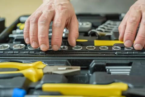 A man took tool from a case for work. Close up Stock Photos