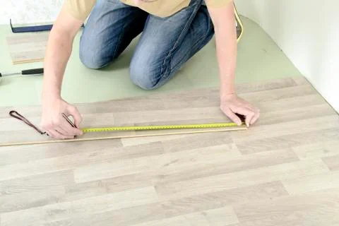 Man with Tools to Laying Laminate Stock Photos