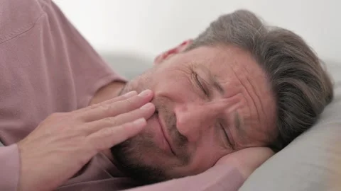 Man with Toothache Lying on Side in Bed Video stock 287410504