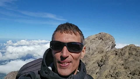 Man on the top of Mount Agung, Bali, Indonesia. Stock Footage 282563042
