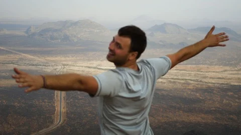 Man On The Top Of The Mountain Hands To The Sides And Depicts The Flight Stock Footage 97830226