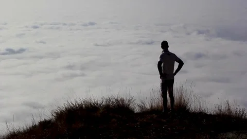 Man In The Top Of A Mountain Looking At Clouds Stock-Footage 126532853