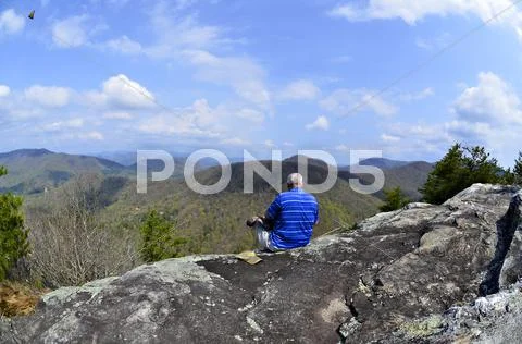 Man on top of a mountain Stock Photos