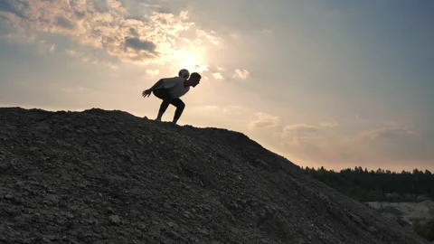Man on top of the mountain shows tricks with the ball. Stock Footage 133522047