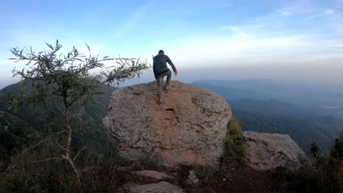 Man on top of mountain standing on the rock watching a view at Doi Luang Stock Footage 155087690