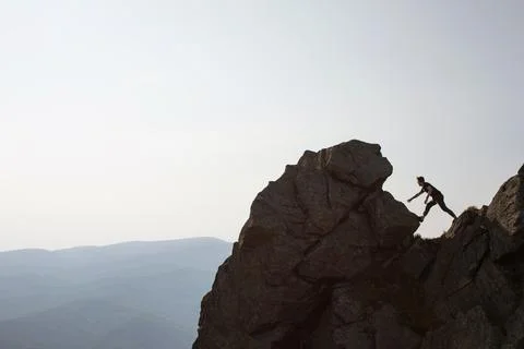 Man on the top of the rock Stock Photos