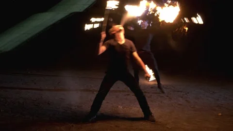 Man with a torch breathes fire. Two men spinning chains of fire. Fire show 스톡 동영상 140199310