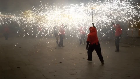 Man with a torch from a fireworks dancing at night during a fire procession Video stock 126978839