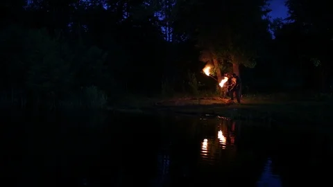 The man with the torch kindles a fire Stock Footage 122823289