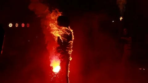 A man with torches in a burning comfor Vídeo Stock 79159586