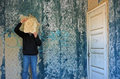 Man with torn wallpaper Stock Photos