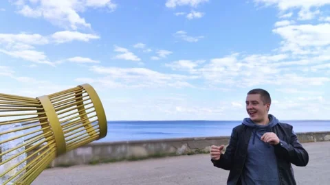 A man tosses a plastic bottle into a plastic container for collection. Recycling Video stock 153525719