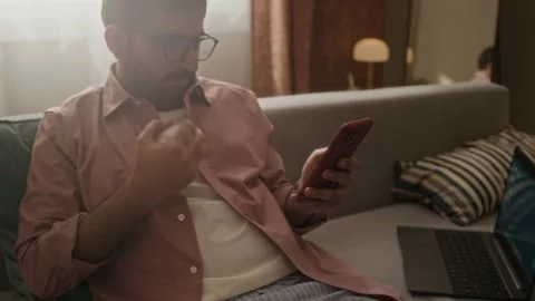 Man Tossing Baseball and Using Smartphone during Remote Work Stock Footage 337719690