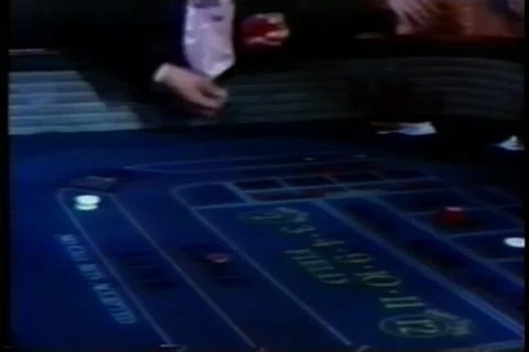 Man tossing dice on craps table in casino Stock Footage 11345339