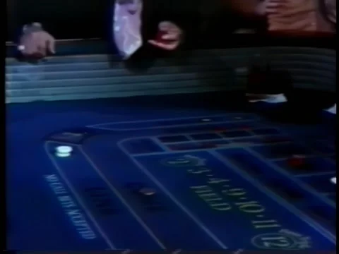 Man tossing dice on craps table in casino Stock Footage 260247072