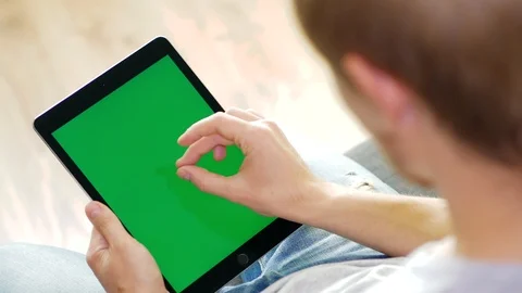 Man touch gesture zoom in with tablet green Stock Footage 97109485