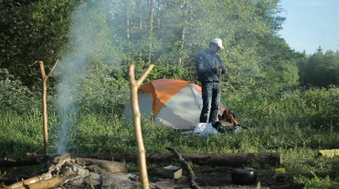 Man touch smartpwatch in camping Stock Footage 64058182