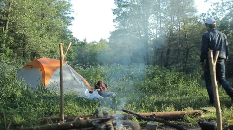 Man touch smartpwatch in camping Stock Footage 64058235